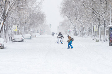 Snowboarder and skiers enjoying in the streets of Madrid City during a historical Snowtorm, Madrid,...