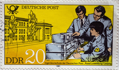 GERMANY, DDR - CIRCA 1981 : a postage stamp from Germany, GDR showing Students of the "Rosa Luxemburg" engineering school of Deutsche Post, Leipzig. Educational institutions of the Deutsche Post