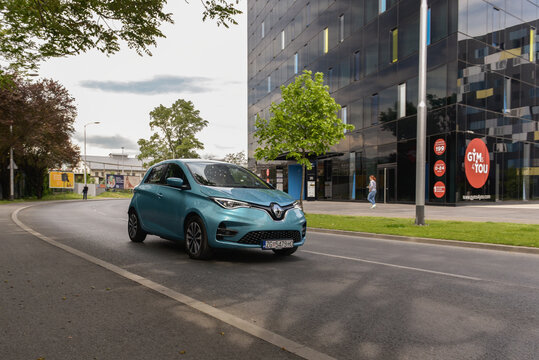 New Renault Zoe electrical car. New modern technology. Electric power vehicle with modern glass building in background.