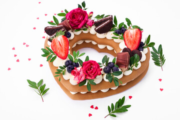 Biscuit cake - a heart-shaped cake with cream and fruit. Dessert on Valentine's Day.