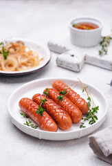 Grilled sausages with roasted onion