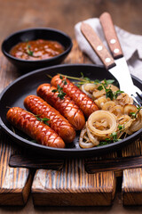 Grilled sausages with roasted onion