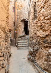 Narrow alleyway in the old mountain village Misfat Al Abriyeen in Sultanate of Oman.