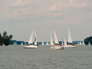 Beldany lake, Masuria, Poland, 28 of July 2020. Many yachts sailing during windy summer day.