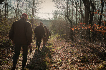 hunters walking in the forest
