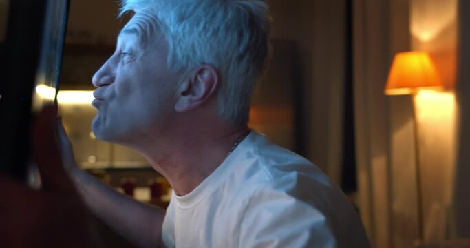 Excited Old Man Watching Football Match On Tv Late In Evening