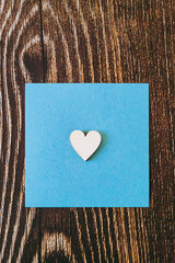 Coeur en bois sur un carré bleu avec fond en bois et espace vide - Arrière plan Saint-Valentin
