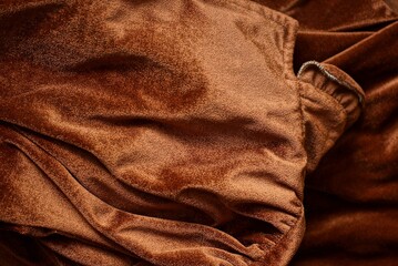 Fototapeta premium dark brown background of fabric from a crumpled piece of cloth