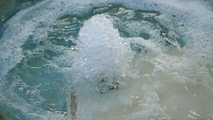 Slow aperture shot freezing water motion in famous fountain of Fontana di Trevi, Rome, Italy