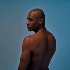 Man with a perfect body watching over his shoulder