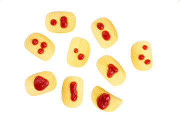 Naklejka premium potato chips with ketchup isolated on a white background, top view.