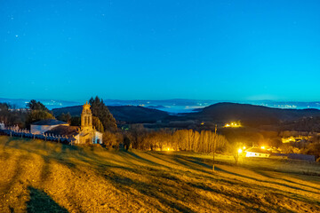 Night sky over a church and cemetery in Spain
