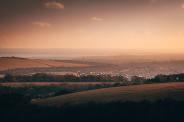 Hills overlooking a Hampshire village in the south Coast during a sunset.