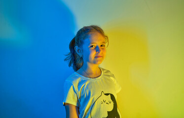 Little girl smiling over ocher background