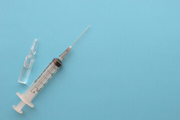 medical syringe with ampoule on a blue background