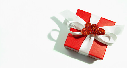 red gift box with white bow and red isolate hearts, copy space