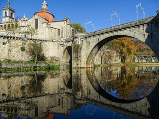 Fototapeta na wymiar Reflection in water, mirror, buildings and bridge in Peso da Regua, visiting Portugal.