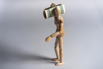 Wooden man toy figure with money on white background. Business concept.