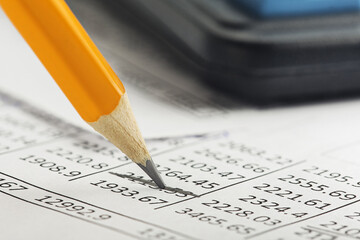 Accounting document with pencil, and checking financial chart. Concept of banking, financial report and financial audit.