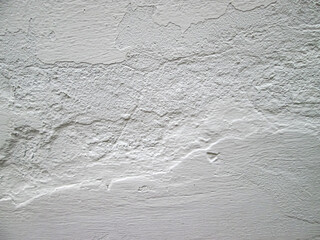 Obraz premium Rough white surface on the wall. Whitewashing a room in the house. Old photo effect.