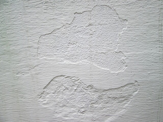 Texture of scuffs and cracks on a white wall. Stock photo to create a retro effect.