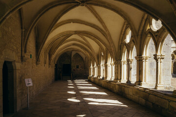 Fototapeta na wymiar the alley of the gothic cloister of the Noirlac abbey, a monastery situated in Berry region (France)