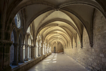 Fototapeta na wymiar the alley of the gothic cloister of the Noirlac abbey, a monastery situated in Berry region (France)
