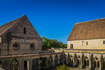 View on the cloister and the church of the Noirlac abbey, a beautiful gothic monastery in Berry region, France
