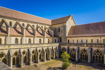 View on the cloister and the church of the Noirlac abbey, a beautiful gothic monastery in Berry...