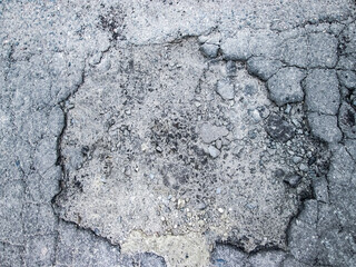 A pit on an asphalt road. Stock photo for the effect of destruction.