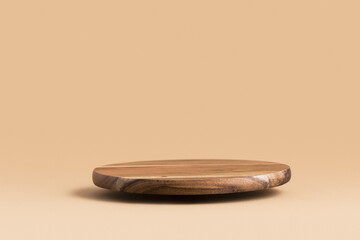 Round wooden flying podium for food, products or cosmetics against bright brown background. - obrazy, fototapety, plakaty