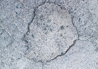 The texture of the destroyed asphalt. Unsuitable stone surface.