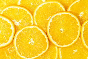 Bright orange fruit slices textured background.