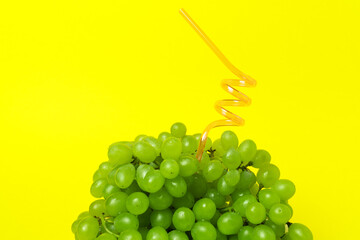 Bunch of sweet seedless grape with straw. Juicy fruits concept.