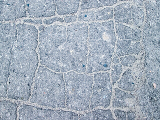 Old cracked asphalt pavement. The road broke. The texture of the destroyed city.