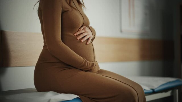 Young Female Patient Visiting a Modern Family Health Care Clinic. Pregnant Woman Waiting for Her Medical Test Results in Obstetrics and Gynecology Doctor's Hospital Office. Waiting for Physician.