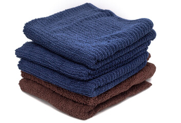 Bath towels of different colors one on top of the other isolated on a white background