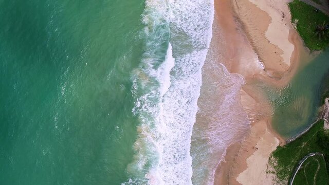 Aerial view drone move Beautiful tropical sandy beach with white sand Wave crashing on sandy shore Top view empty and clean beach.Beautiful Phuket beach is famous tourist destination at Andaman sea