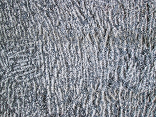 Stone texture with lines and depressions. Gray background with stone pavement.