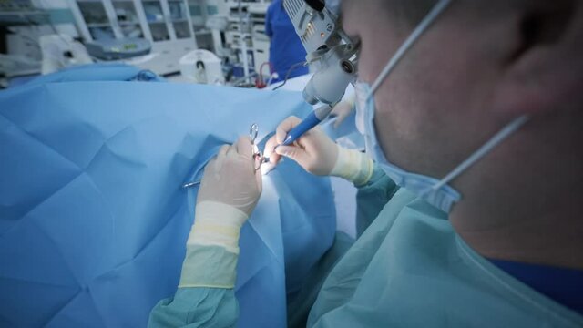 Operation of removing tonsils. tonsillectomy under deep anesthesia, using latest devices, cold plasma method, cuts swelling in throat, doctor works with new probe, medical headlamp, surgical loupes