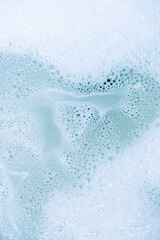water foam and bubbles of blue color as background. cosmetology concept