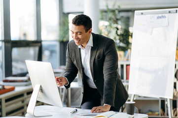 Hispanic male boss discussing new business strategy with employees, talking about future plans of...