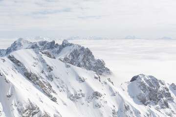 Fototapeta na wymiar Sunny Dachstein Mountains Above The Sea Of Fog