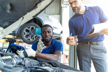 Mechanic discuss together in garage