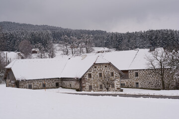 Old Farm Houses With Stone Walls In Snowy Winter Landscape