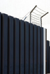 Fence With Barbed Wire On Top