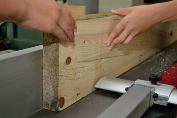 Wooden Board Is Treated By Carpenter With A Planer