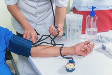 Senior man on medical check-up checking blood pressure