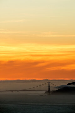 vertical image of golden gate bridge at sunset taken from Lawrence Hall of Science in Berkeley