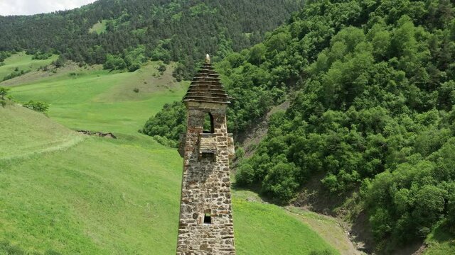 Aerial around view of medieval tower complex in the mountains of Ingushetia, Russia, 4k
